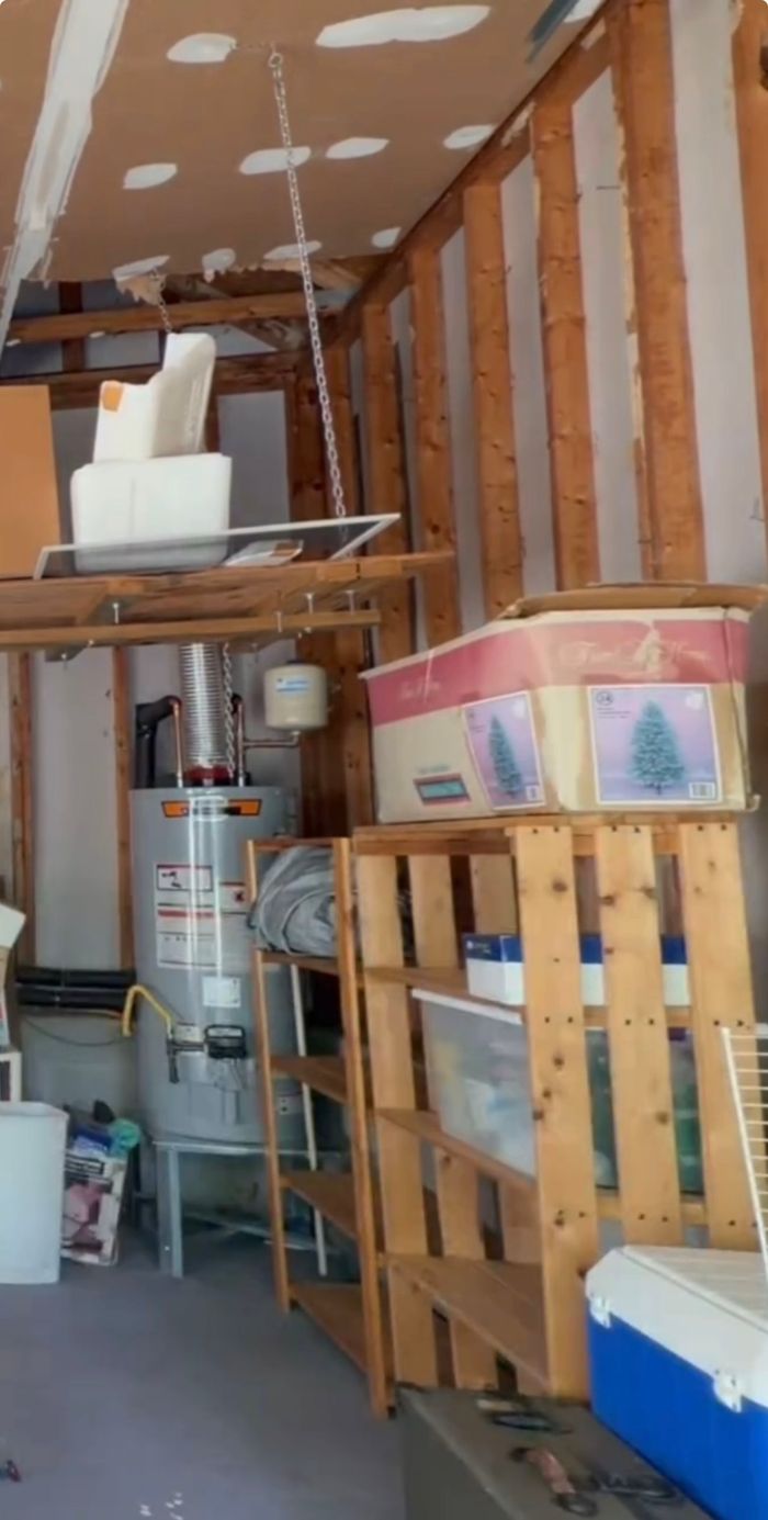 The same garage after cleaning, with shelves organized and the floor clear
